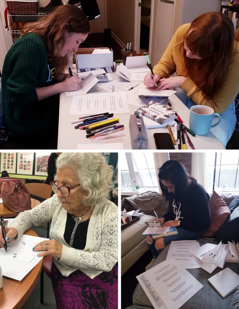 volunteers and participants work at a card-writing gathering