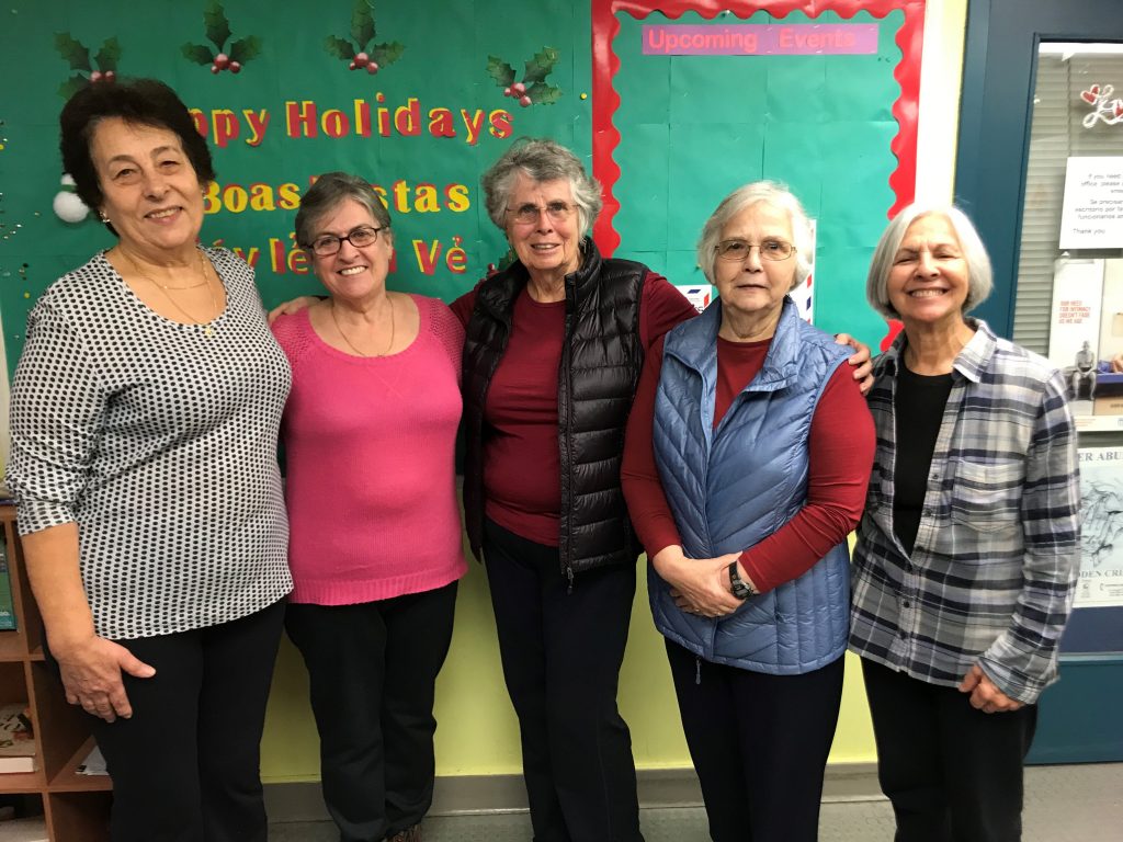 Charlene and other volunteers pose for a photo at the older adult centre