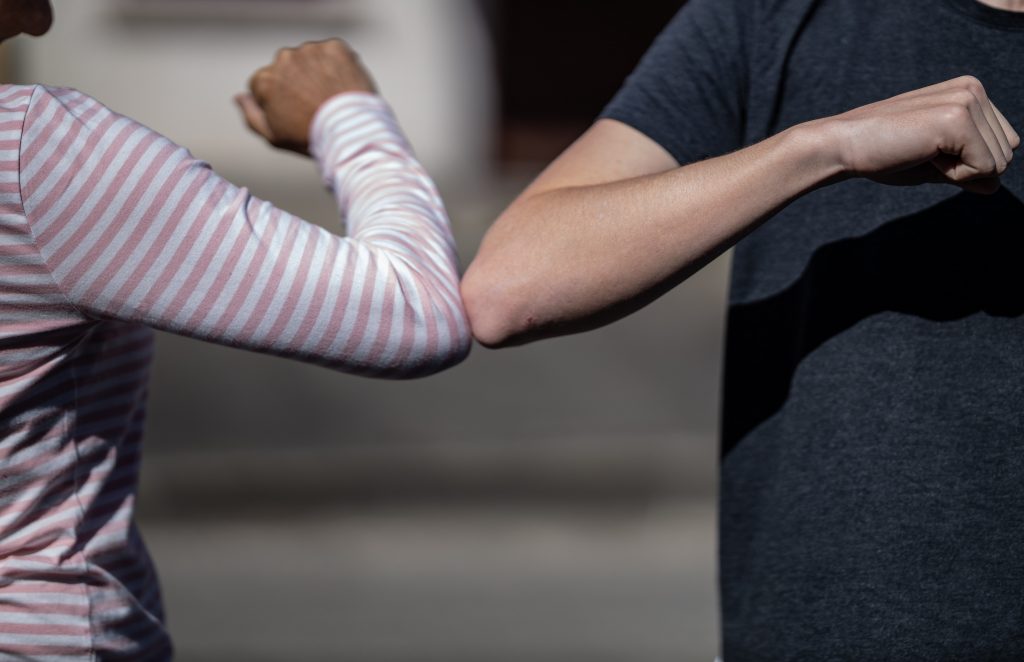 elbow-bump for safety. Hand shapes are not safe.