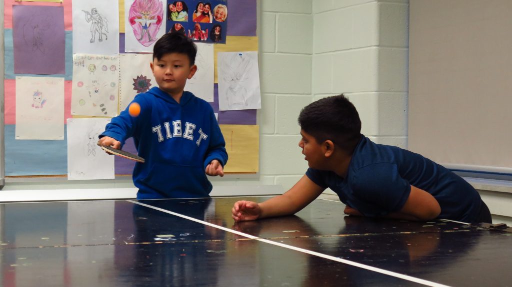 Two boys play with ping pong during the After School Program
