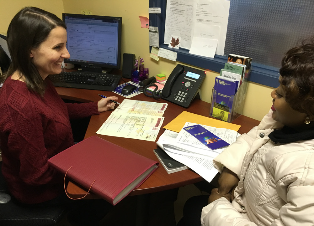 A participant speaks to a case worker as part of the Newcomer Settlement Program