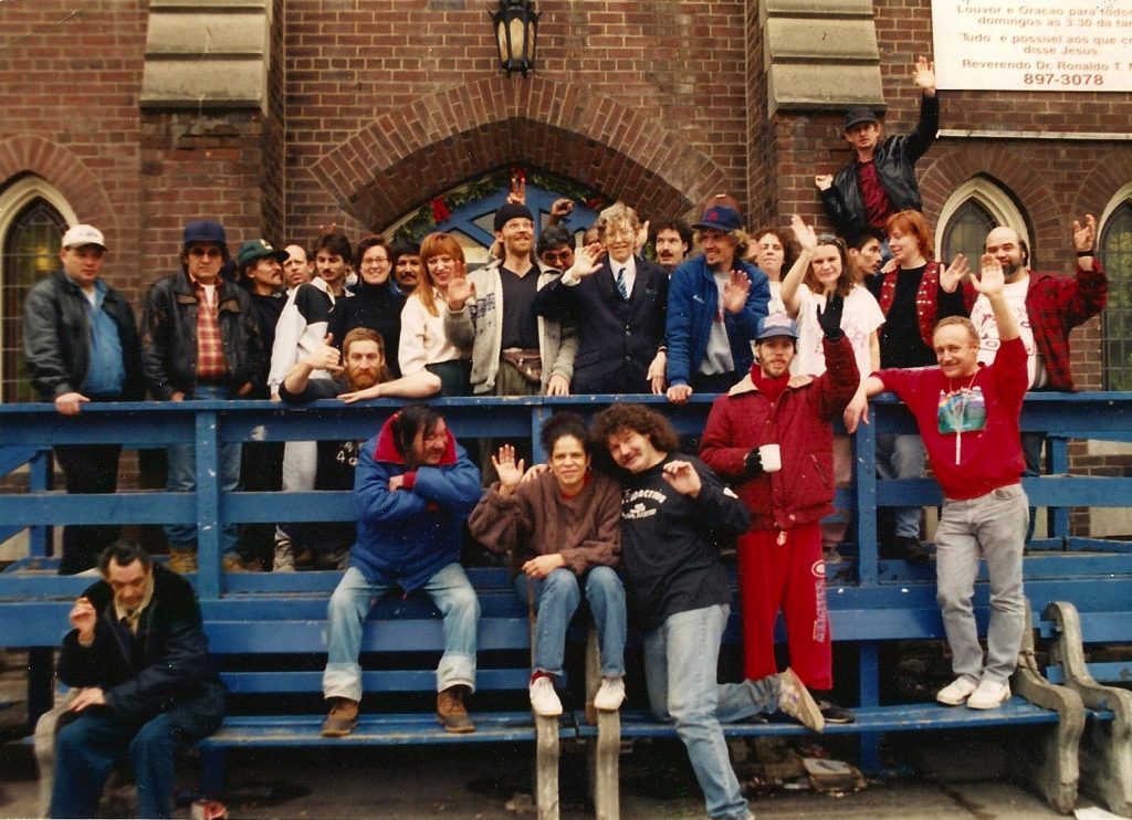 A group of people stand in front of the Meeting Place in 1986