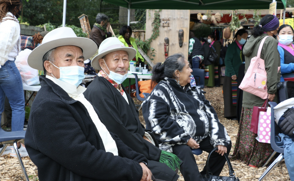 Three people sitting down at the Greenest City Harvest festival.