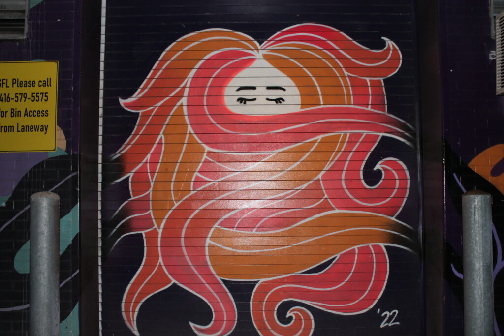 Street art of a person with wavy hair