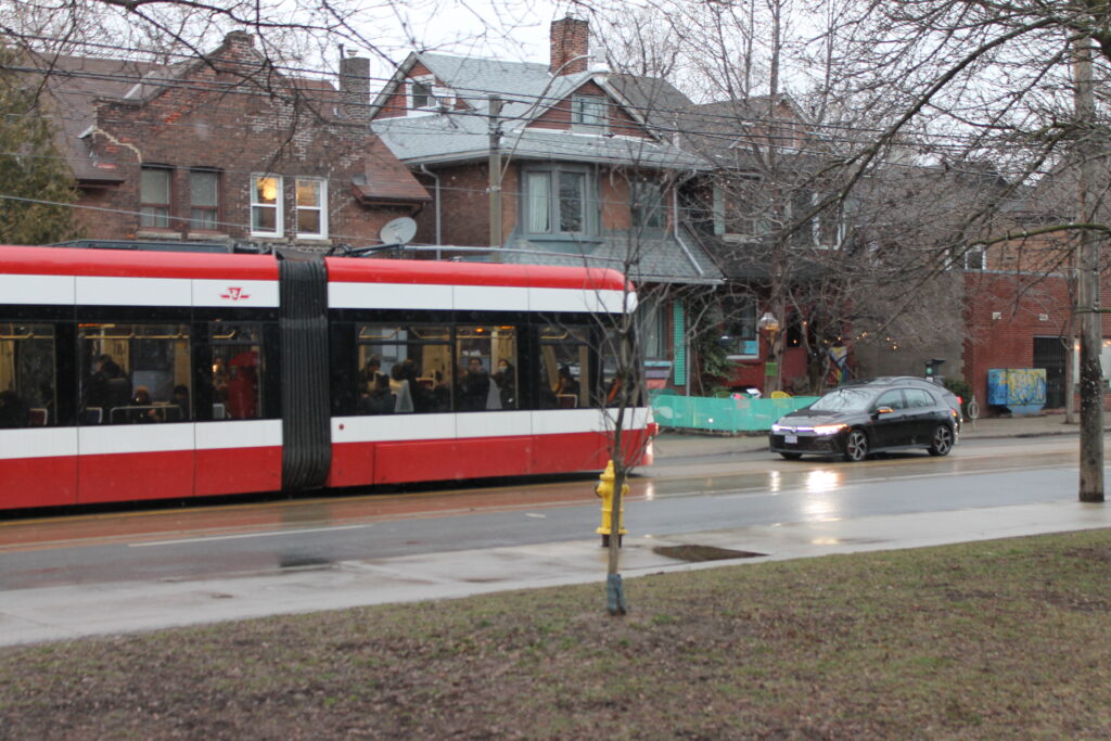 Streetcar and car passing one another