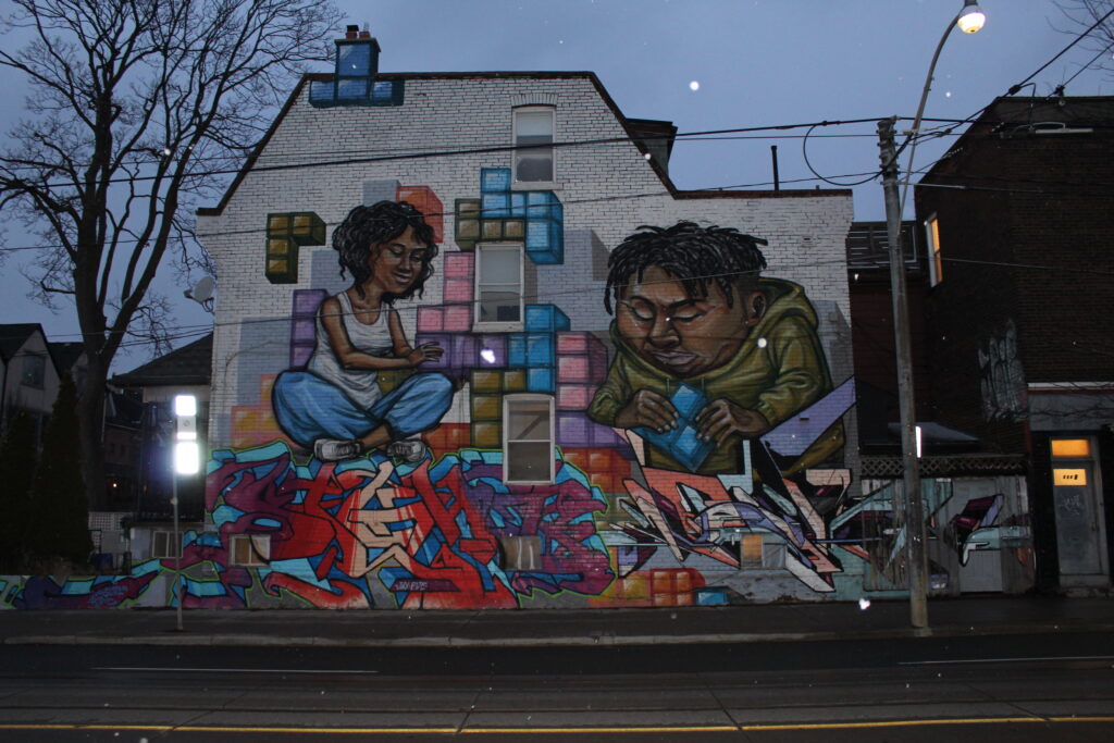 A house with street art of two people playing jenga.
