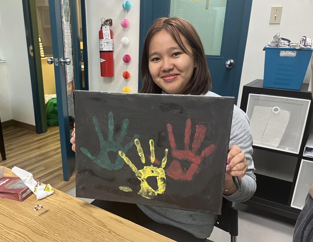 Girl holding up painting