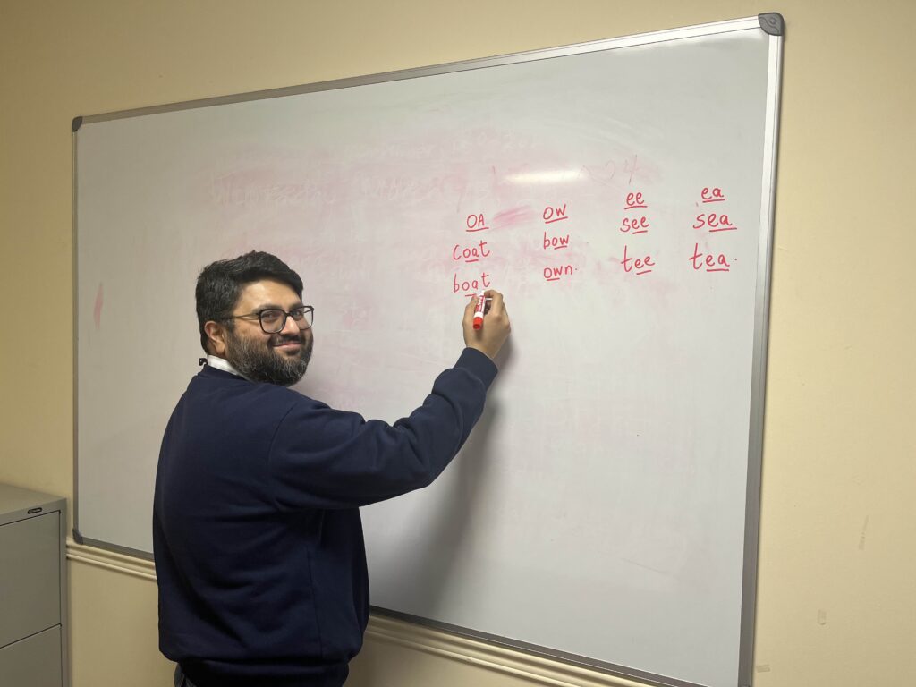 Volunteer tutor writing on a board