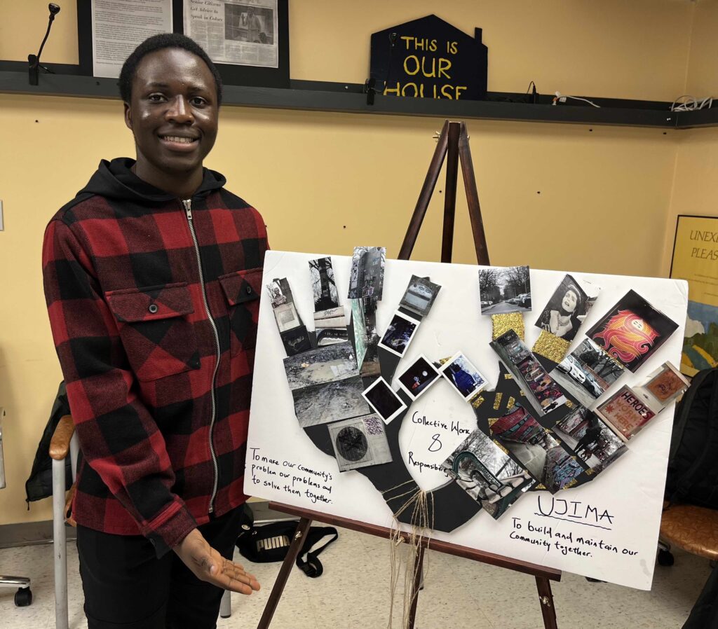 Young man standing in front of art work