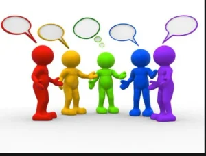 A group of five 3D stylized human figures in different colours standing in a semi-circle on a white background, engaged in a discussion.
